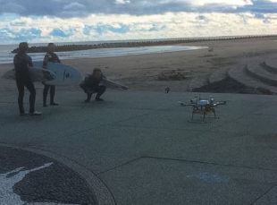 Test of drone testing delivering warm drinks to surfers. (c) METI